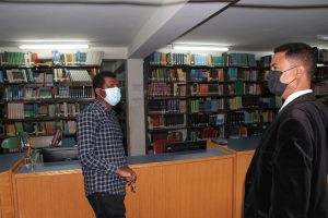 Assistance Professor Tilahun with someone in professor Gabisa Library
