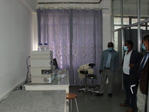 Dr. Lema wogi Showing Visitors his office machine equipment